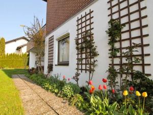 a white house with flowers in the front yard at Ferienwohnung Nain in Bad Dürrheim