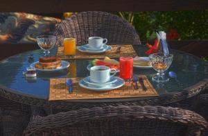 a table with a tray of breakfast food on it at Pousada da Encosta in Garopaba