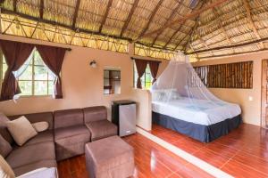 a living room with a couch and a bed at Hotel Mariposa in León +36 photos