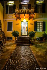 a front door of a building at night at Nostos Hotel in Galaxidi