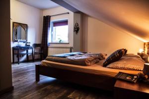 a bedroom with a bed with a desk and a window at Apartamenty Pan Tadeusz Ustroń in Ustroń +65 photos