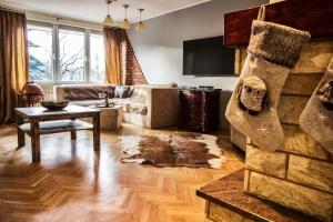 a living room with a couch and a table at Apartamenty Pan Tadeusz Ustroń in Ustroń