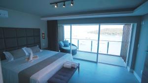 Ein Bett oder Betten in einem Zimmer der Unterkunft Caixa D'aço Exclusive Hotel