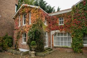 a brick house with ivy on the side of it at Ballsbridge Apartments in Dublin