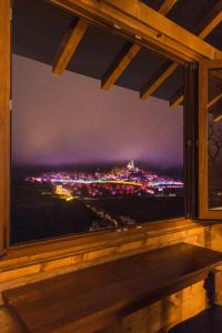 a window with a view of a city at night at Tsarevets Residence in Veliko Tŭrnovo