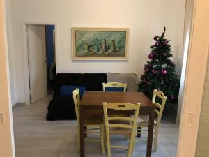a dining room with a table and a christmas tree at Trilocale sul Mare in Fano