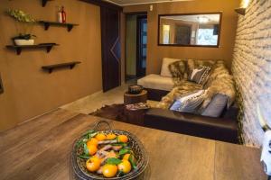 a living room with a bowl of fruit on a table at Apartamenty Pan Tadeusz Ustroń in Ustroń