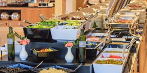 a buffet line with food and bottles of wine at Grand Lubicz Uzdrowisko Ustka in Ustka