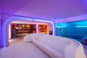 a living room with a large white couch in a room at Grand Lubicz Uzdrowisko Ustka in Ustka