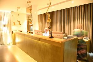 a woman sitting at a desk with two laptops at The Port Hotel in Visakhapatnam