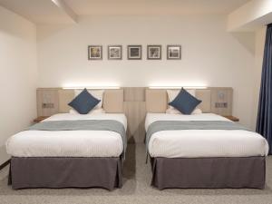 Postel nebo postele na pokoji v ubytování HOTEL MYSTAYS Midosuji Honmachi