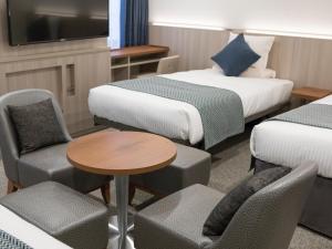 Postel nebo postele na pokoji v ubytování HOTEL MYSTAYS Midosuji Honmachi