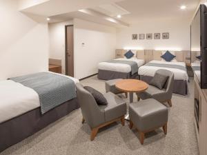 Postel nebo postele na pokoji v ubytování HOTEL MYSTAYS Midosuji Honmachi