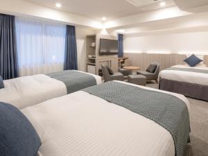 Postel nebo postele na pokoji v ubytování HOTEL MYSTAYS Midosuji Honmachi