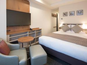 Postel nebo postele na pokoji v ubytování HOTEL MYSTAYS Midosuji Honmachi