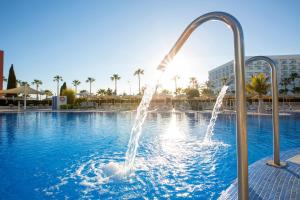 a fountain in a swimming pool in a resort at Hipotels Cala Millor Park in Cala Millor