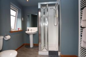 a bathroom with a shower and a sink at The Square Kintore in Kintore