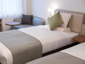 Postel nebo postele na pokoji v ubytování HOTEL MYSTAYS Midosuji Honmachi