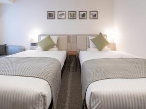 Postel nebo postele na pokoji v ubytování HOTEL MYSTAYS Midosuji Honmachi