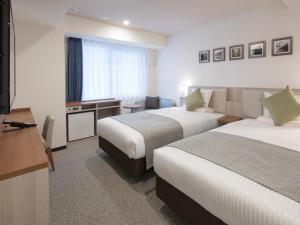 Postel nebo postele na pokoji v ubytování HOTEL MYSTAYS Midosuji Honmachi