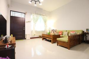 a living room with a couch and a table at Happy Together Guesthouse in Taitung City