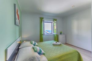 Postel nebo postele na pokoji v ubytování Apartment Adriano