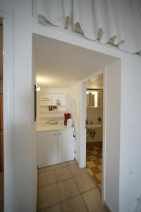 a white kitchen with a sink and a bathroom at Seaside Apartments in Adamantas +56 photos