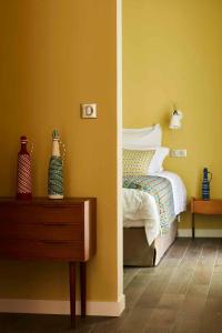 a bedroom with a bed and a table with a night stand at Eden Lodge Paris in Paris