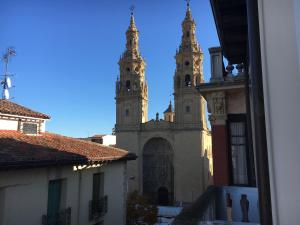 two towers of a church with two buildings at Hostal La Numantina in Logroño