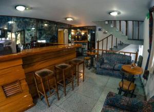 a bar in a restaurant with chairs and tables at Apart Hotel Magali in Córdoba