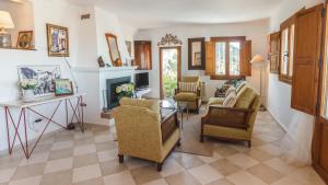 a living room with chairs and a fireplace at Casa Alta Mojacar Pueblo in Mojácar