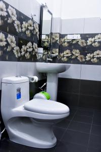 a bathroom with a white toilet and a sink at Otha Shy Airport Transit Hotel in Katunayaka +52 photos