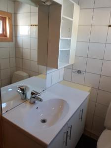 a bathroom with a white sink and a mirror at Knutebu Two-Bedroom Cottage in Geilo