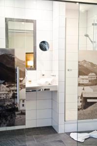 a bathroom with a sink and a mirror at Hotel Garni Arosa in Ischgl