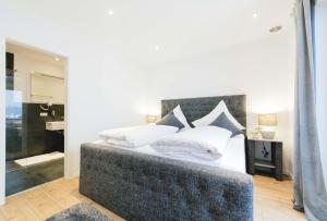 a bedroom with a large bed with white pillows at Unique Inn in Schöngeising