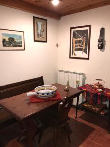 a dining room with a wooden table and chairs at In Mansarda Da Vanni in Rivisondoli