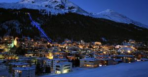 a view of a city in the snow at night at Ferienwohnung Alpenblick in Davos