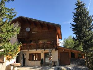 a large wooden house with a balcony at Boost Your Immo Vars Le Regain 6 in Vars