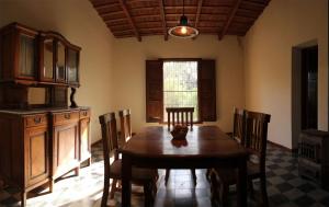 a dining room with a wooden table and chairs at Cabañas Estancia Balumba in Capilla del Monte