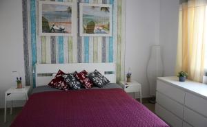 a bedroom with a purple bed with pillows on it at Casa Marinero with Private Pool in Puerto del Rosario +20 photos