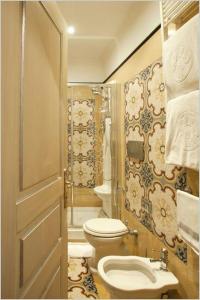 a bathroom with a toilet and a sink at Hotel Aventino in Rome