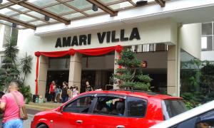 a red car parked in front of a amazon villa at 3 Bedrooms at Lagoon Park Resort in Melaka