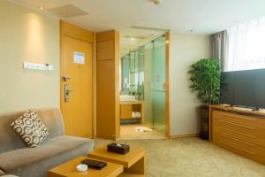 a living room with a couch and a tv at Metropolo, Guangzhou, Wanda Plaza-Baiyun Mountain in Guangzhou