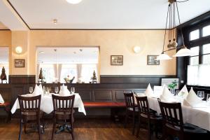 a dining room with white tables and chairs at Zu den Drei Linden - Hotel & Restaurant in Wermelskirchen
