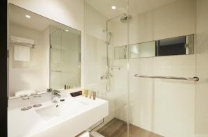 a white bathroom with a sink and a shower at GLAD Gangnam COEX Center in Seoul