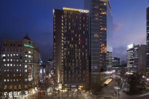 a tall building in a city at night at GLAD Gangnam COEX Center in Seoul