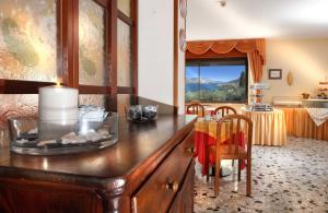 a kitchen with a counter and a dining room with a table at Casa Antonelli in Malcesine