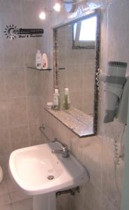 a bathroom with a sink and a mirror at Appartamenti Baia Verde Gallipoli di Carlino Tourist in Gallipoli