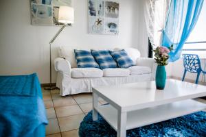 sala de estar con sofá blanco y mesa en Krasas Beach Apts, en Lárnaca