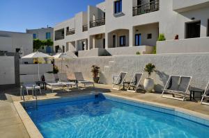 a swimming pool with chairs and a building at Casa Bianca Adults Only "by Checkin" in Hersonissos +43 photos